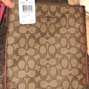 Coach crossbody purse with pink trim